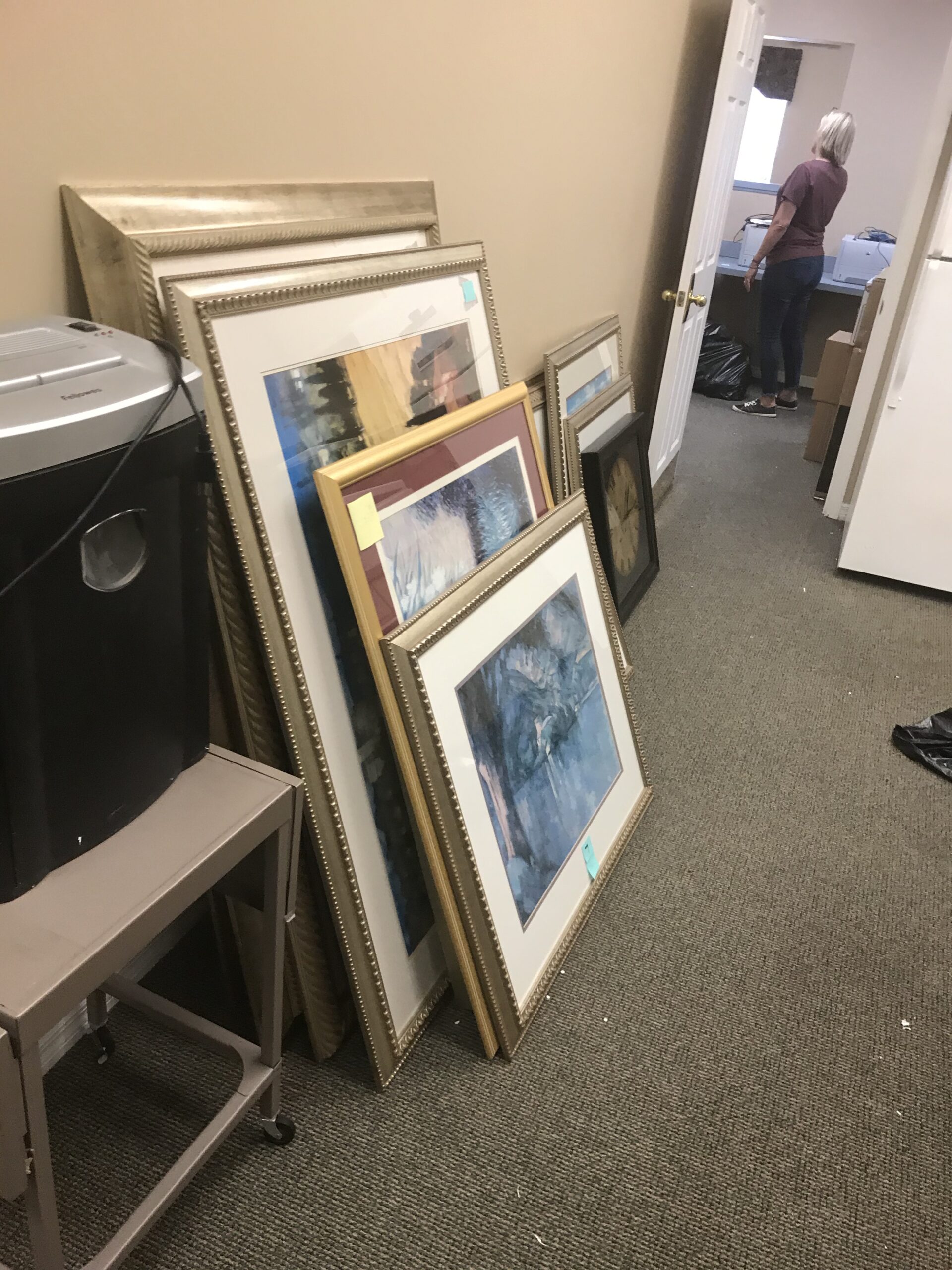Framed artwork in storage for office move